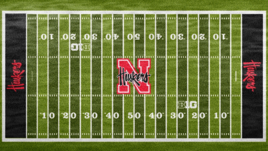 aerial view of nebraska field with black endzones and big N and huskers in the middle