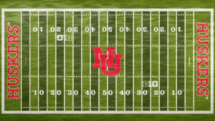 aerial view of field with NU in the middle in red and huskers outlined in red in each endzone